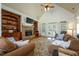 Cozy living room with stone fireplace, custom built-ins, hardwood floors, and natural light at 815 Spring View Ct, Covington, GA 30014