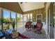 Cozy sunroom with views of the surrounding nature and comfortable seating arrangement at 815 Spring View Ct, Covington, GA 30014