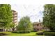 Apartment building exterior surrounded by lush green landscaping and mature trees on a sunny day at 1800 Clairmont Lk # 216, Decatur, GA 30033