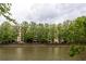 Apartment building view from across the pond, framed by lush green trees at 1800 Clairmont Lk # 216, Decatur, GA 30033
