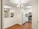 Bright dining room with chandelier adjacent to open kitchen and mirror accent wall at 1800 Clairmont Lk # 216, Decatur, GA 30033
