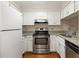 Well-maintained kitchen featuring stainless steel appliances, granite countertops, and white cabinets at 1800 Clairmont Lk # 216, Decatur, GA 30033