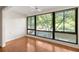 Living room with hardwood floors, ceiling fan and large window with green outdoor views at 1800 Clairmont Lk # 216, Decatur, GA 30033