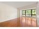 Spacious living room features hardwood flooring and large window with green outdoor views at 1800 Clairmont Lk # 216, Decatur, GA 30033