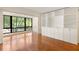 Bright living room with a wall of built-in shelving and cabinets plus a large picture window at 1800 Clairmont Lk # 216, Decatur, GA 30033