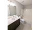 Updated bathroom featuring a white sink vanity and shower-tub combo, ideal for relaxation at 225 Kentshire Pl, Lawrenceville, GA 30044