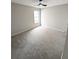 Bright carpeted bedroom featuring a ceiling fan, offering a comfortable and serene space at 225 Kentshire Pl, Lawrenceville, GA 30044