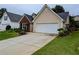 Inviting home showcasing a well-maintained lawn and a two-car garage at 225 Kentshire Pl, Lawrenceville, GA 30044