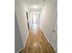Bright hallway featuring hardwood floors, neutral paint, and modern lighting at 225 Kentshire Pl, Lawrenceville, GA 30044