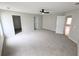 Large, carpeted main bedroom with a ceiling fan and ensuite bathroom, offering a comfortable retreat at 225 Kentshire Pl, Lawrenceville, GA 30044