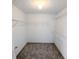 A well-organized, carpeted walk-in closet with shelving, providing ample storage space at 225 Kentshire Pl, Lawrenceville, GA 30044
