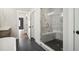 Bathroom featuring a glass door shower, a bathtub, and gray tile at 591 Brashy St, Woodstock, GA 30188