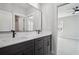 Bathroom featuring double vanities with modern fixtures and a large mirror at 591 Brashy St, Woodstock, GA 30188