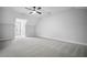 Spacious bedroom featuring neutral carpet, ceiling fan, and natural light at 591 Brashy St, Woodstock, GA 30188