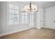 Bright dining room with modern light fixture and lots of natural light at 591 Brashy St, Woodstock, GA 30188