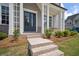 Home front entrance with brick steps, columns, and a charming double-door entry at 591 Brashy St, Woodstock, GA 30188
