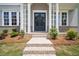 Home front entrance with brick steps, columns, and a charming double-door entry at 591 Brashy St, Woodstock, GA 30188