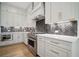 Stylish kitchen featuring stainless steel appliances, custom cabinetry, and sleek countertops at 591 Brashy St, Woodstock, GA 30188