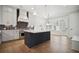Modern kitchen with a large island, stainless steel appliances, and sleek, pendant lighting at 591 Brashy St, Woodstock, GA 30188