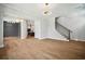 Spacious open-concept living room with hardwood floors, modern lighting, and a staircase at 591 Brashy St, Woodstock, GA 30188