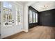 Bright interior with a view of the front yard, featuring a statement wall and modern lighting at 591 Brashy St, Woodstock, GA 30188