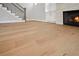 Spacious living room with hardwood floors, a fireplace, and a staircase with dark iron railings at 591 Brashy St, Woodstock, GA 30188