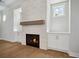 Cozy living room featuring a stone fireplace, built-in cabinets, and light-colored wood floors at 591 Brashy St, Woodstock, GA 30188