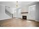 Living room featuring a modern fireplace, hardwood floors, and staircase at 591 Brashy St, Woodstock, GA 30188