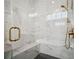 Stylish shower featuring marble tile, rainfall showerhead, and built in bench at 591 Brashy St, Woodstock, GA 30188