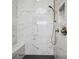 Modern shower featuring stylish tile, rainfall showerhead, and built in bench at 591 Brashy St, Woodstock, GA 30188
