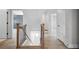 Bright staircase featuring hardwood floors and iron railings at 591 Brashy St, Woodstock, GA 30188