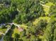Scenic aerial perspective highlighting a house nestled within a dense landscape with a winding driveway at 75 Auburn Rd, Auburn, GA 30011