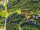 Aerial view of a wooded property with clearly defined boundaries, showcasing a house surrounded by lush greenery at 75 Auburn Rd, Auburn, GA 30011