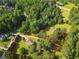 Aerial view of a property with defined borders, showcasing a house with surrounding trees and lawn at 75 Auburn Rd, Auburn, GA 30011