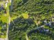Expansive aerial view of a wooded property featuring lush greenery and a charming neighborhood at 75 Auburn Rd, Auburn, GA 30011