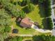 Aerial view of a well-maintained home with a lush lawn, mature trees, and a long driveway at 75 Auburn Rd, Auburn, GA 30011