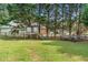 Large grassy backyard with play area and partial fencing at 75 Auburn Rd, Auburn, GA 30011