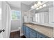 Bathroom with granite countertop and blue vanity with decorative mirror at 75 Auburn Rd, Auburn, GA 30011