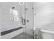 Modern tiled shower with a built-in bench and glass door at 75 Auburn Rd, Auburn, GA 30011