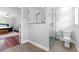 Elegant bathroom with a modern glass shower, commode and view to main bedroom at 75 Auburn Rd, Auburn, GA 30011