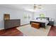 Serene bedroom with hardwood floors, dresser, and a comfortable bed for restful nights at 75 Auburn Rd, Auburn, GA 30011