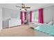 Bright bedroom with a ceiling fan, neutral carpet and pink accents at 75 Auburn Rd, Auburn, GA 30011