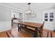 Elegant dining room with a rustic wood table, modern lighting, and views into the kitchen at 75 Auburn Rd, Auburn, GA 30011