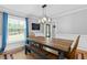 Inviting dining room with a wooden table and bench seating, complemented by elegant blue curtains at 75 Auburn Rd, Auburn, GA 30011