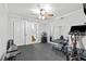 Inviting exercise room featuring workout equipment, mirror, and ceiling fan for comfortable workouts at 75 Auburn Rd, Auburn, GA 30011