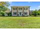 Charming two-story home with a manicured front lawn and a welcoming entrance with a blue door at 75 Auburn Rd, Auburn, GA 30011
