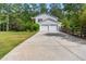 Inviting two-story home featuring a long driveway and a two-car garage nestled among mature trees at 75 Auburn Rd, Auburn, GA 30011