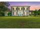 Elegant two-story brick home with a lush green lawn and a bright, inviting blue front door at 75 Auburn Rd, Auburn, GA 30011