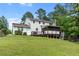 Exterior view of backyard with large lawn, porch, and deck at 75 Auburn Rd, Auburn, GA 30011