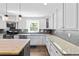 Bright kitchen features granite countertops, stainless steel appliances, and modern pendant lighting at 75 Auburn Rd, Auburn, GA 30011